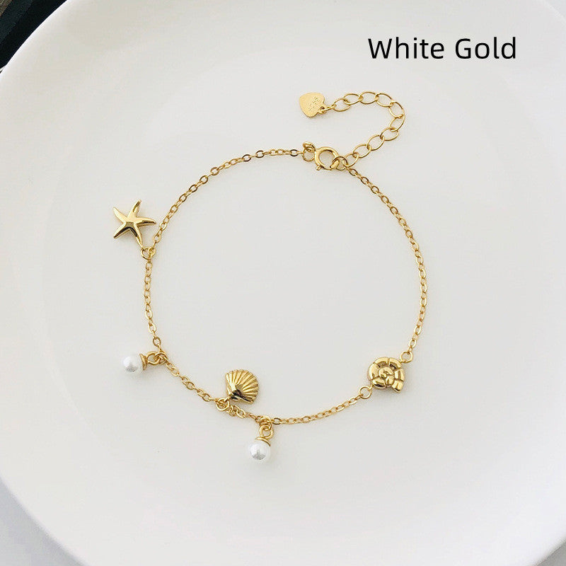 Damemote elegant skallperlearmbånd